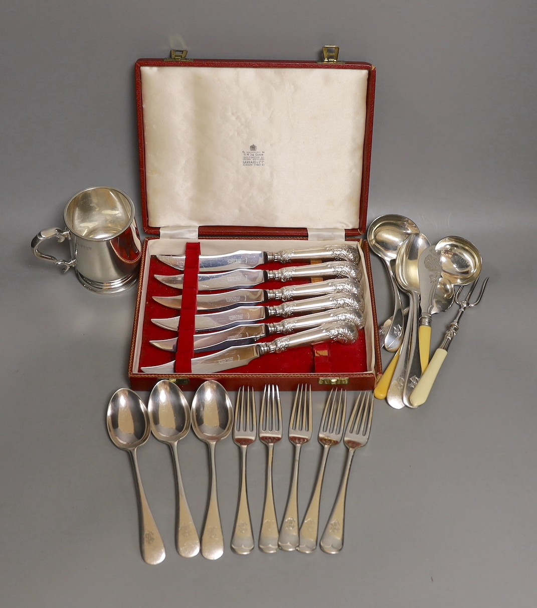 A cased set Garrard pistol handled steak knives, other plated cutlery and a plated mug